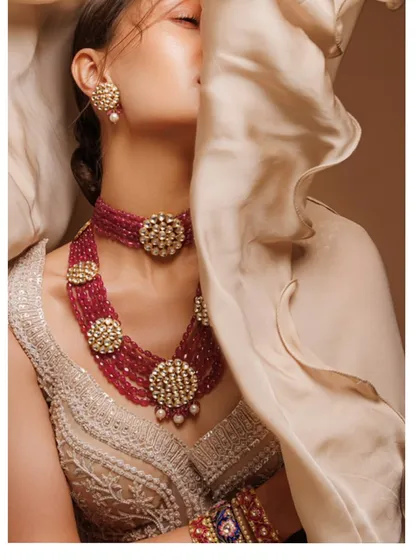 Jewellery is the soul of a bridal look. For this campaign, I focused on a magnificent multi-layered ruby and polki choker set against a finely embroidered Tarun Tahiliani blouse. This demonstrates my approach to accessory curation, where each piece is chosen to complement the outfit and enhance the bride's radiance.