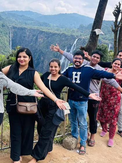 A fun, synchronized pose by our group with the magnificent Jog Falls in the background, a popular stop on our Gokarna trips.