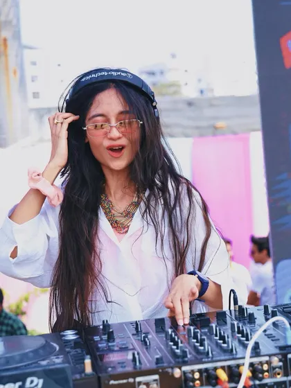 Adjusting the sound during a sunny Holi set. Ensuring perfect audio quality is crucial, especially in an outdoor environment.