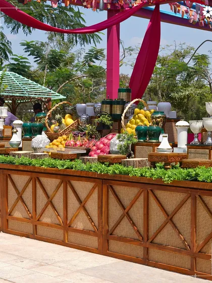 A wide shot of the beautiful fruit and beverage station at a Bengaluru wedding. We use fresh, local produce to create displays that are as beautiful as they are delicious.