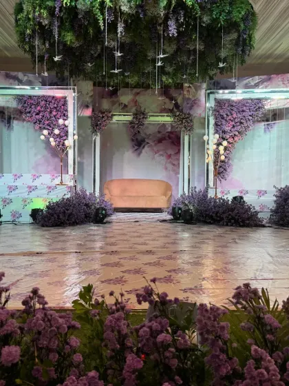 A dreamy lavender-themed reception stage. We use a blend of florals, lighting, and custom backdrops to create a modern and romantic ambiance for your evening celebration.