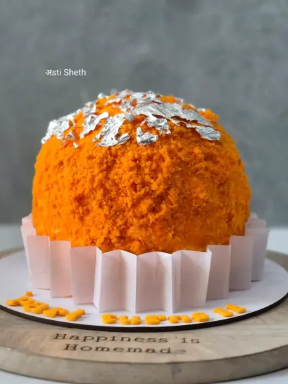 This Motichoor Ladoo inspired cake is a unique creation from my archives. The cake is covered in orange-colored cake crumbs to resemble a ladoo and topped with edible silver leaf for a festive, fusion dessert.