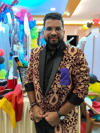 Standing by my table of props. Magic is the art that makes the whole world happy, and I am glad to be one of its artists.