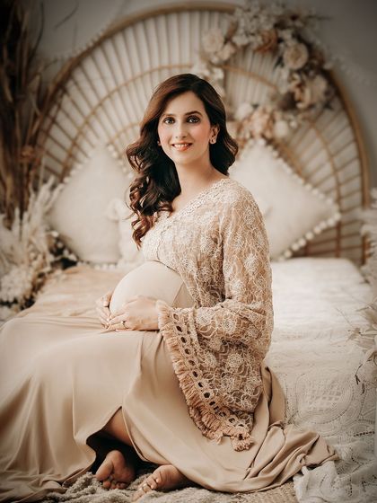 A smiling portrait from one of our boho-themed setups. The rattan headboard, pampas grass, and warm tones create a relaxed, earthy, and stylish atmosphere.