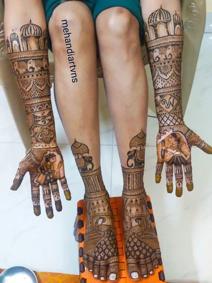 This full bridal set includes portraits, elephants, and palace-inspired domes on the arms, with complementary elephant and peacock designs on the feet.