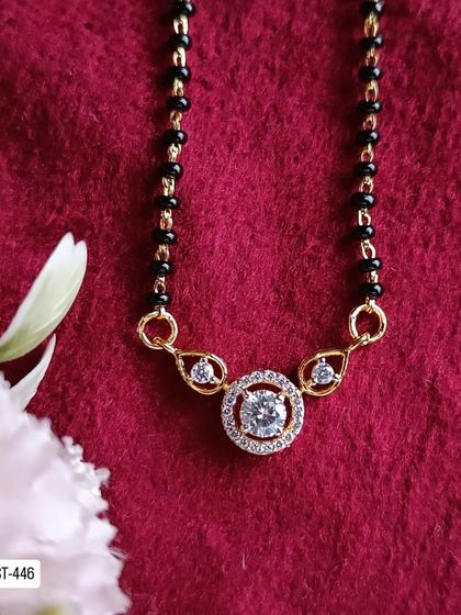 Another look at the classic solitaire-style mangalsutra. The central American diamond is the star of this simple yet beautiful piece.