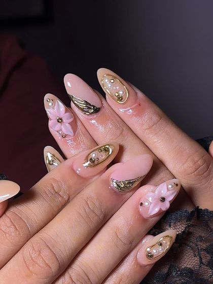 A different view of the bride's sister's nails, highlighting the delicate gold and pearl embellishments.