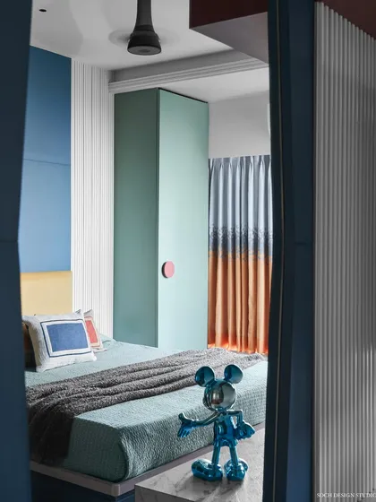 A glimpse into the playful kids' room, with its vibrant color blocking and fun decor elements.