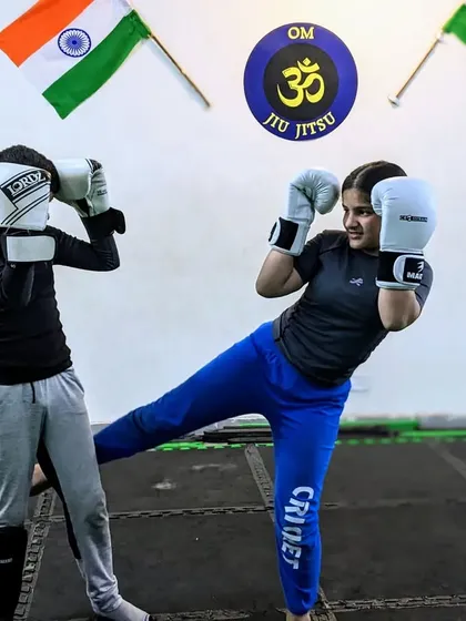 A strong foundation is key. This young student is practicing her kickboxing form, learning the fundamentals of striking that will build her confidence and character.