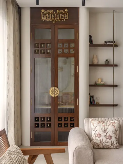 Craftsmanship is at the core of my work. This custom-designed wooden puja room door features intricate details like small brass bells and a traditional metal motif, transforming a functional element into a piece of art that sets a tone of devotion and peace.