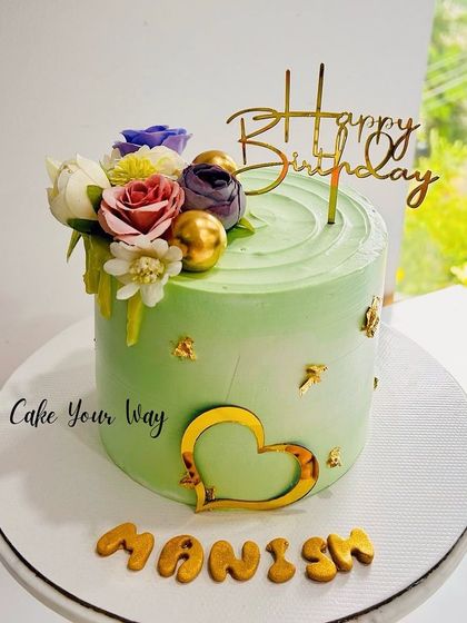 Making life sweeter, one bite at a time. A simple green cake with a floral accent.