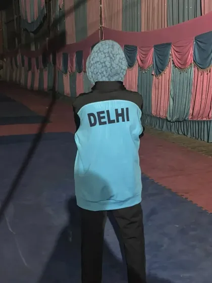 Representing Delhi. Ayush Kumar proudly wearing his team jacket before competing at the Sub-Junior National Championship.