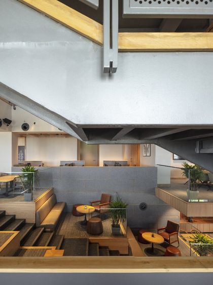 A detail of the structural elements at Primarc shows the honest use of materials. The exposed steel beams and raw concrete are balanced by the warmth of wood, creating an industrial yet refined aesthetic.