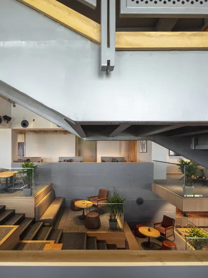 A detail of the structural elements at Primarc shows the honest use of materials. The exposed steel beams and raw concrete are balanced by the warmth of wood, creating an industrial yet refined aesthetic.