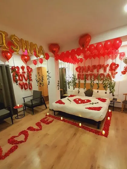 Surprise your loved one with the ultimate romantic birthday room decoration. This setup transforms any bedroom with red heart-shaped balloons, hanging vines, rose petals on the floor and bed, and personalized foil balloons, creating an unforgettable and intimate celebration.