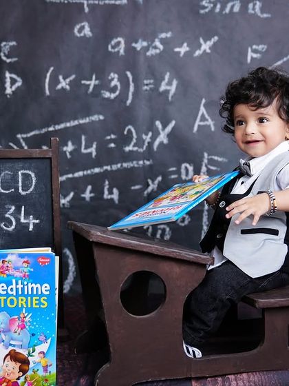 A little student ready for his books! This first birthday shoot features a cute "back to school" theme with a chalkboard and colorful books.