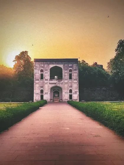 A view of a subsidiary tomb within the Humayun's Tomb complex at sunset. The entire area is a necropolis, with many smaller tombs of Mughal nobility scattered throughout the gardens.