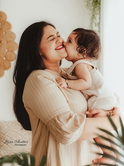 A sweet baby kiss for mom. These are the spontaneous, love-filled moments we aim to freeze in time during our relaxed family photography sessions.
