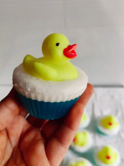Holding one of the duck toy soaps to show its size and the fun, bubbly base.