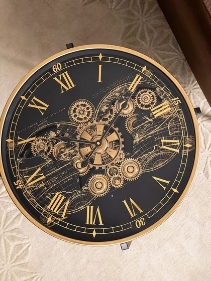 A top-down view of our clock table, showing the detailed world map design and moving gears under the glass surface. It's a perfect blend of design aesthetics and functionality.