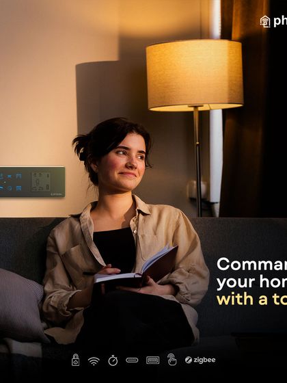 Command your home with a touch. Here, a user enjoys the convenience of my wall-mounted smart panel, which provides centralized control without disrupting the calm and cozy atmosphere of the room.