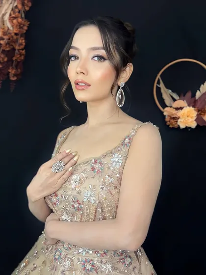 A full view of this perfect reception glam look. The embellished gown is balanced with soft makeup and a classic hairstyle, creating a look of pure elegance.