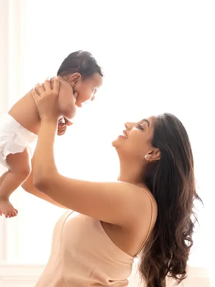 A mother's joy as she lifts her baby up into the light. The bright, airy feel of this photo perfectly matches the happy emotion.