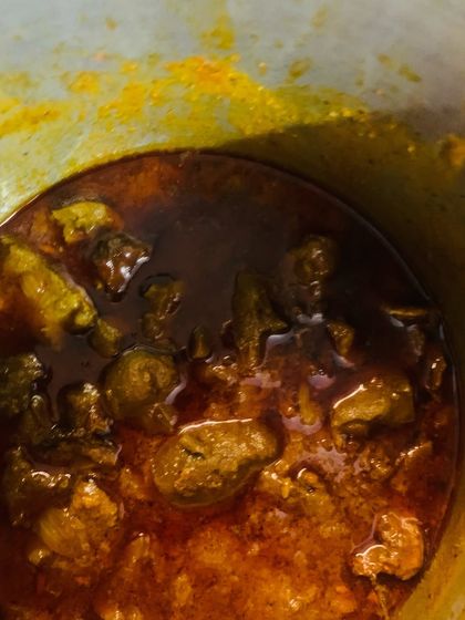 Two of my favourite dishes cooking. On the left, smoked pork with Aneshi (fermented taro leaves) and bamboo shoot juice. On the right, my spicy beef liver pickle with gallbladder, simmering in mustard oil.