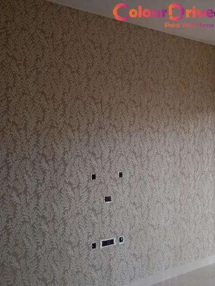 Even a subtle pattern can make a big impact. This delicate leaf-patterned wallpaper covers an entire wall, adding a soft, textured feel to the room and making it feel complete.