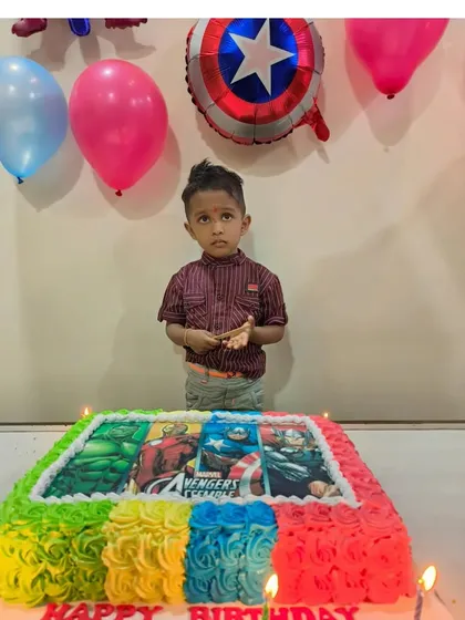 Assemble the heroes for a birthday celebration with this Avengers photo cake. The colorful buttercream border frames an edible image of Iron Man, Captain America, and the Hulk, perfect for a young superhero fan.