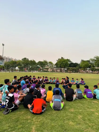 A wide shot of our players gathered for the physiotherapy session on our home ground. We are committed to their complete well-being.