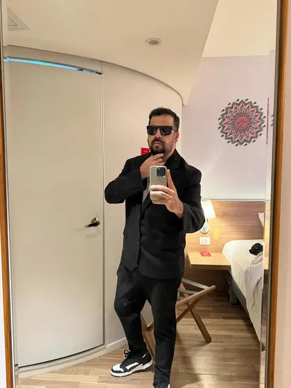 A mirror selfie showing off my look for a private event. I dress the part, whether it's a casual club night or a formal wedding gig.