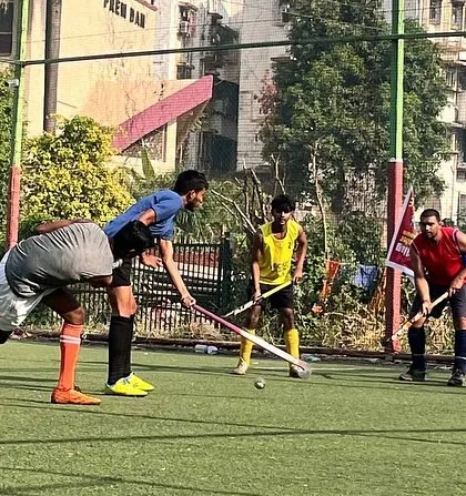 A tense moment as players fight for control of the ball near the center of the field. Every practice is a chance to compete.