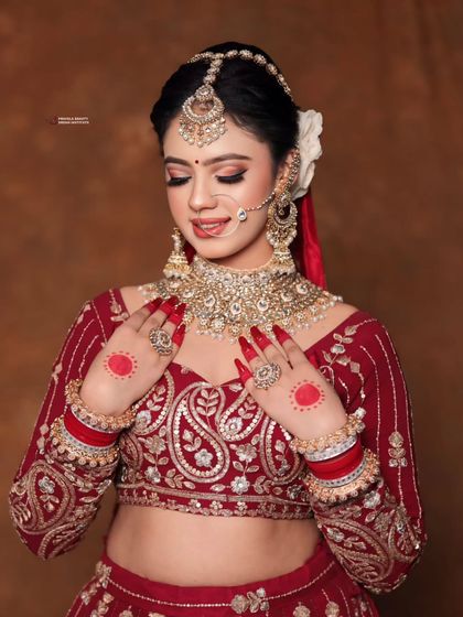 A moment of quiet beauty. The soft, romantic makeup with a classic red lip is perfectly balanced by the traditional hair and jewelry, creating a look that is both stunning and heartfelt.