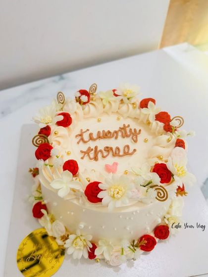 Turning twenty-three never looked so beautiful. A dreamy floral cake with soft swirls, edible blooms, and golden pearls.