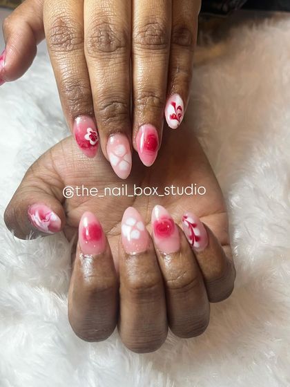 A close-up showing the delicate hand-painted art on these extensions. The combination of blooming gel effects and fine line work creates a stunning, multi-dimensional look.