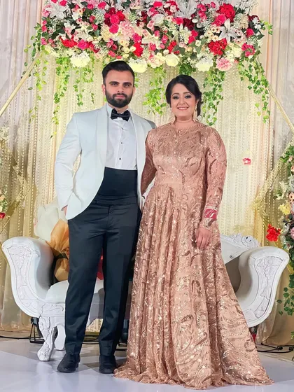 A beautiful couple ready for their reception. I created a sophisticated evening look for the bride with a classic updo and shimmering makeup that complemented her ornate gown.
