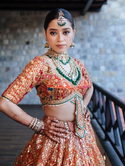 A powerful portrait of a bride in a regal Rimple & Harpreet lehenga, her pose exuding confidence and grace.