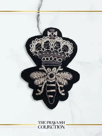 The same crowned bee patch, this time embroidered in striking silver thread. This version offers a cooler, more contemporary alternative to the classic gold design.