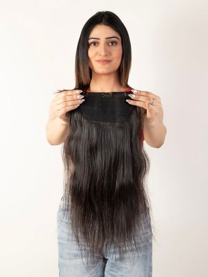 A model displaying the top of a hair weft, showing how it attaches.