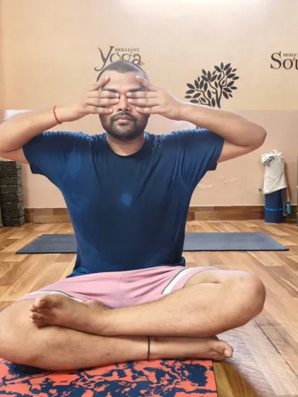A close-up of a student practicing the 'bee breath'. This is a core technique I teach for managing anxiety and lowering blood pressure naturally.