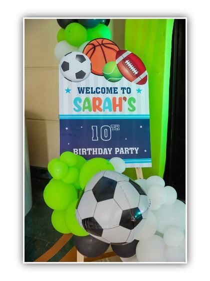 A personalized welcome sign for Sarah's 10th sports-themed birthday party, decorated with various sports balls and balloons.
