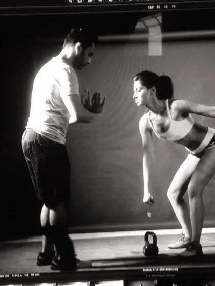 Behind the scenes, coaching an athlete on proper kettlebell swing form. Technique is everything.
