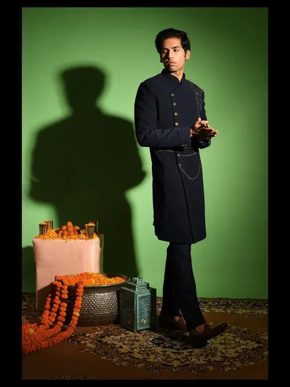 A full length look at the asymmetric Indo western outfit. Paired with tailored trousers, this ensemble is perfect for a cocktail party, reception, or any event where you want to make a contemporary style statement.