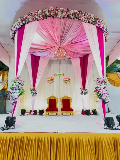 A beautiful canopy-style mandap for an engagement ceremony. I used pink and white drapes to create a royal tent effect, complete with a chandelier and floral arrangements.