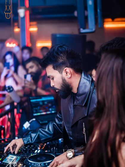 A close-up of me fine-tuning the mix on my Pioneer controller. The details matter when it comes to creating a smooth and energetic set.