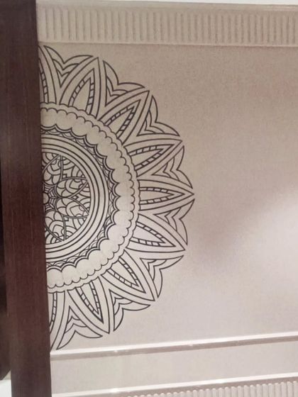 A detailed shot of the half-mandala mural, showcasing the clean lines and symmetrical patterns.