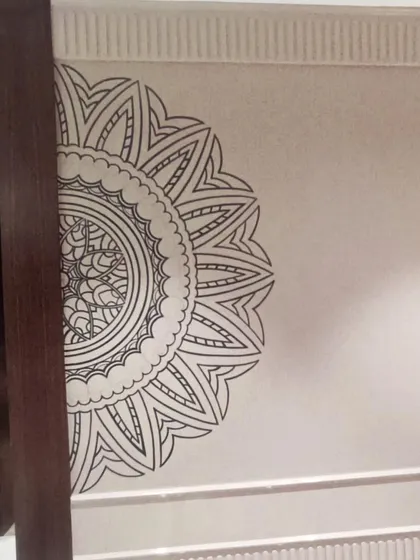 A detailed shot of the half-mandala mural, showcasing the clean lines and symmetrical patterns.