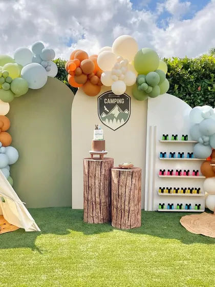 Why just have a party when you can have an adventure? This outdoor camping theme, complete with a teepee tent and log-style cake stands, is an example of how I can create a unique, interactive experience for a truly memorable birthday.