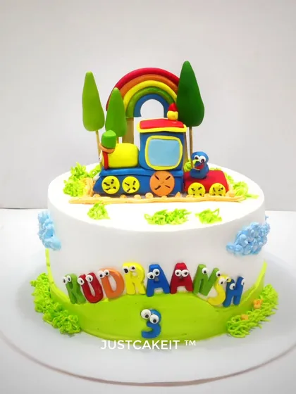 A charming and simple train theme cake for a third birthday celebration. The colorful engine and edible name blocks make it a delightful treat for any little train enthusiast.